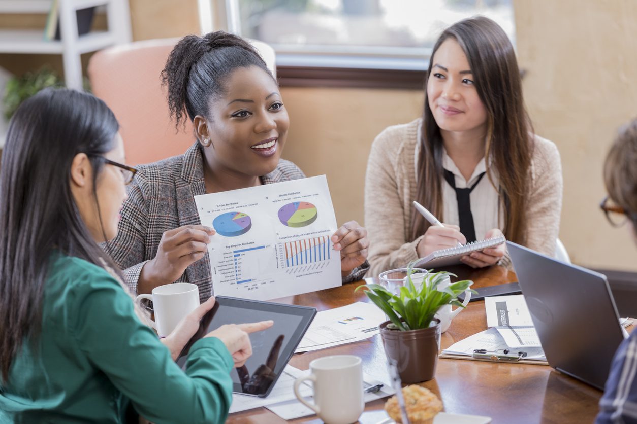 a businesswoman shows colleagues a document