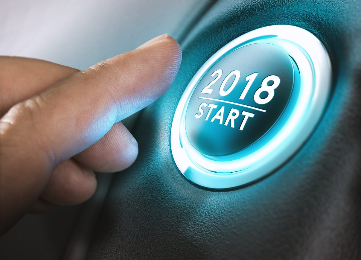 Hand pressing a 2018 start button