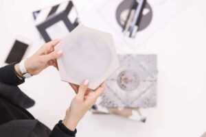 Close-up of a woman holding a hexagon tile—representing how leaders may exclude great talent without realizing it when focusing on culture fit.